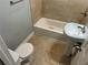 A bathroom featuring tile flooring, a pedestal sink and a shower-tub combo at 490 Rockwell Sw St, Atlanta, GA 30310