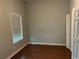 A bedroom showcases a window that allows natural light to brighten the hardwood floors at 490 Rockwell Sw St, Atlanta, GA 30310