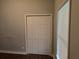 Bedroom closet with bi-fold doors, window and hardwood flooring at 490 Rockwell Sw St, Atlanta, GA 30310