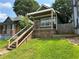 Charming renovated home with a covered porch, stone accents, new wooden steps, and fresh landscaping at 490 Rockwell Sw St, Atlanta, GA 30310