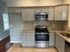 Kitchen featuring stainless steel appliances, granite countertops, and gray cabinetry at 490 Rockwell Sw St, Atlanta, GA 30310