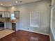 Open living room with hardwood floors, large windows, and an adjacent kitchen area at 490 Rockwell Sw St, Atlanta, GA 30310