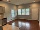 Open living room with hardwood floors and large windows and an adjacent kitchen area at 490 Rockwell Sw St, Atlanta, GA 30310