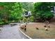 Backyard oasis with stone pathways, garden accents, and free-range chickens at 5120 Jett Forest Trl, Atlanta, GA 30327