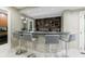 This wet bar offers seating for four and features granite countertops and stylish upper cabinets for storage at 5120 Jett Forest Trl, Atlanta, GA 30327
