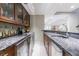 The basement bar features granite countertops, under-counter beverage coolers, and glass-front upper cabinets at 5120 Jett Forest Trl, Atlanta, GA 30327