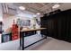 Basement featuring a wooden workbench, pegboard, ample storage, and black privacy curtains at 5120 Jett Forest Trl, Atlanta, GA 30327