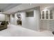 Basement wall with fireplace feature and built-in storage cabinets for an organized living area at 5120 Jett Forest Trl, Atlanta, GA 30327