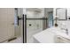 Well-lit bathroom with an enclosed tub featuring black and white accents and a framed window at 5120 Jett Forest Trl, Atlanta, GA 30327