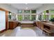 Spacious bathroom featuring double vanities, soaking tub, tile floors, and natural light at 5120 Jett Forest Trl, Atlanta, GA 30327