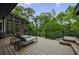 Inviting wooden deck with lounge chairs showcasing a serene outdoor area surrounded by beautiful trees at 5120 Jett Forest Trl, Atlanta, GA 30327