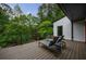 Scenic deck featuring lounge chairs and railing with views of surrounding trees and a home exterior at 5120 Jett Forest Trl, Atlanta, GA 30327
