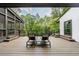 Relaxing outdoor deck with chairs and lush green views surrounded by mature trees and foliage at 5120 Jett Forest Trl, Atlanta, GA 30327