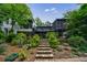 Modern home featuring a screened porch, balconies, and lush landscaping at 5120 Jett Forest Trl, Atlanta, GA 30327