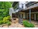 Exterior of home with spiral staircase, stone patio, and mature landscaping at 5120 Jett Forest Trl, Atlanta, GA 30327