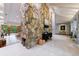 Open-concept foyer featuring stone accent walls, modern lighting and seamless flow to living areas at 5120 Jett Forest Trl, Atlanta, GA 30327
