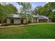 Charming single-story home with stone facade, metal roof and lush green lawn at 5120 Jett Forest Trl, Atlanta, GA 30327
