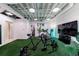 The home gym has an artificial turf floor and is equipped with modern exercise equipment at 5120 Jett Forest Trl, Atlanta, GA 30327