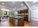 Gourmet kitchen with granite countertops, stainless appliances, custom cabinetry, and open dining area at 5120 Jett Forest Trl, Atlanta, GA 30327