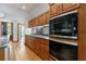 Modern kitchen has wood cabinets, stainless steel appliances, granite countertops, and hardwood floors at 5120 Jett Forest Trl, Atlanta, GA 30327