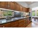 Modern kitchen features granite counters, wood cabinets, stainless steel appliances, and an outdoor view at 5120 Jett Forest Trl, Atlanta, GA 30327