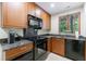 Efficient kitchen with stainless steel appliances, granite countertops, and a scenic window view at 5120 Jett Forest Trl, Atlanta, GA 30327