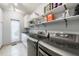 This laundry room includes modern washer and dryer, countertop, storage and a view to the outdoors at 5120 Jett Forest Trl, Atlanta, GA 30327