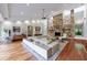 Spacious living room with stone fireplace, modern furnishings, and hardwood floors at 5120 Jett Forest Trl, Atlanta, GA 30327