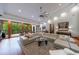 Bright living room featuring a large sectional sofa, hardwood floors, and views of the deck at 5120 Jett Forest Trl, Atlanta, GA 30327
