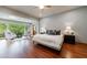 Bright, airy main bedroom with hardwood floors, a sitting area, and a view of the surrounding woods at 5120 Jett Forest Trl, Atlanta, GA 30327