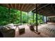 Covered brick patio with outdoor seating surrounded by lush landscaping at 5120 Jett Forest Trl, Atlanta, GA 30327