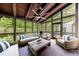 Relax on this screened-in porch with wood floors and wooded views. Ceiling fan helps keep you cool at 5120 Jett Forest Trl, Atlanta, GA 30327