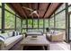 Relaxing sunroom featuring wicker furniture, a ceiling fan, and a wooded outdoor view at 5120 Jett Forest Trl, Atlanta, GA 30327