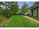 Expansive lawn surrounded by lush greenery, leading to a beautiful home at 5120 Jett Forest Trl, Atlanta, GA 30327