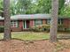 Charming brick home with mature trees and a well-maintained front yard for curb appeal at 5211 Hugh Howell Rd, Stone Mountain, GA 30087