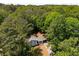 Aerial view of the home and its surroundings, showcasing lush greenery and mature trees at 157 Jousters Ln, Lawrenceville, GA 30044
