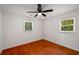 Bedroom with hardwood floors, ceiling fan, and natural light at 157 Jousters Ln, Lawrenceville, GA 30044