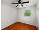 Cozy bedroom with hardwood floors, ceiling fan, and natural light from the window at 157 Jousters Ln, Lawrenceville, GA 30044