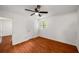 A bright bedroom featuring hardwood floors, a ceiling fan and a sunlit window at 157 Jousters Ln, Lawrenceville, GA 30044
