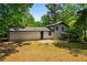 Home exterior with a large backyard, patio, and view of the well-manicured lawn at 157 Jousters Ln, Lawrenceville, GA 30044