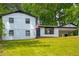 Inviting exterior view of a charming two-story home with manicured lawn and a convenient carport at 157 Jousters Ln, Lawrenceville, GA 30044