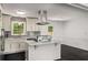 Modern kitchen with white cabinets, stainless steel appliances, and a center island for meal prep at 157 Jousters Ln, Lawrenceville, GA 30044
