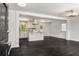 Open-concept living space with hardwood floors, seamlessly connecting to a modern kitchen island at 157 Jousters Ln, Lawrenceville, GA 30044