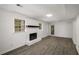 Living room showcasing laminate floors, a stone fireplace and a glass exterior door at 157 Jousters Ln, Lawrenceville, GA 30044