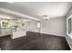 Bright living area featuring hardwood floors and ample natural light, flowing into the kitchen at 157 Jousters Ln, Lawrenceville, GA 30044