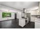 Open concept living room and kitchen featuring modern appliances and dark wood floors at 157 Jousters Ln, Lawrenceville, GA 30044