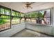 Bright sunroom with white brick accents, screened windows, and ceiling fan perfect for relaxing at 157 Jousters Ln, Lawrenceville, GA 30044