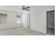 Spacious bedroom featuring neutral carpet, white walls, a ceiling fan, and bright windows at 332 Christian Ln, Carrollton, GA 30116