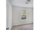 Bright bedroom featuring neutral carpet, white walls, base trim, and a bright window at 332 Christian Ln, Carrollton, GA 30116