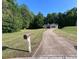 Exterior angle of single story home with long driveway and grassy front yard at 332 Christian Ln, Carrollton, GA 30116